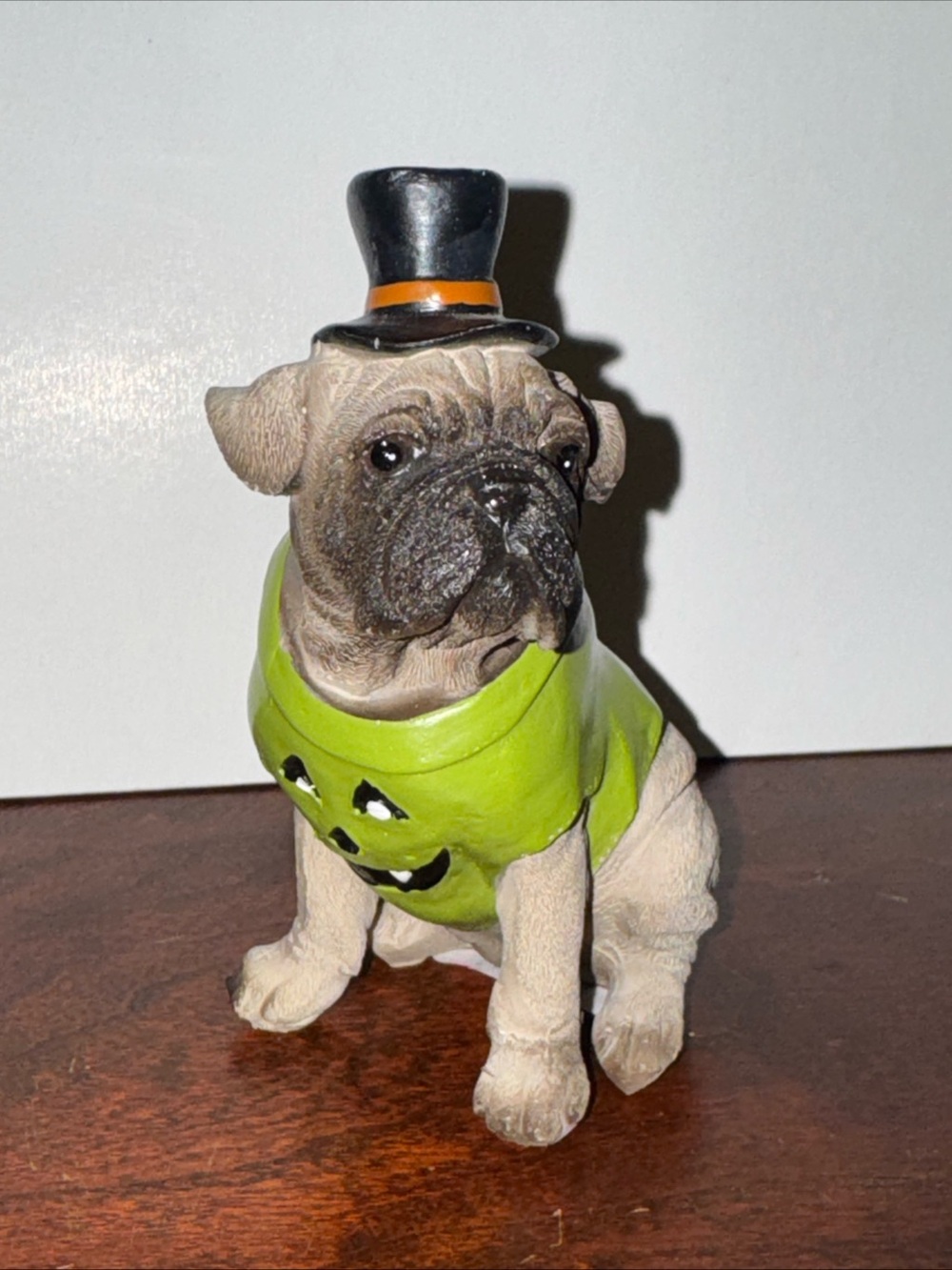 Festive Pug Figurine in Green Halloween Sweater with Black Top Hat